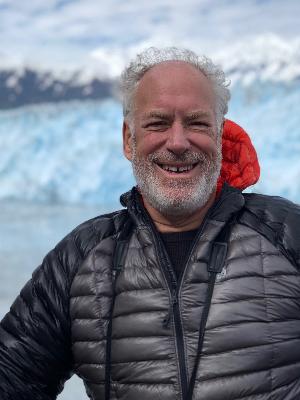 Photo of Dan in front of a glacier.